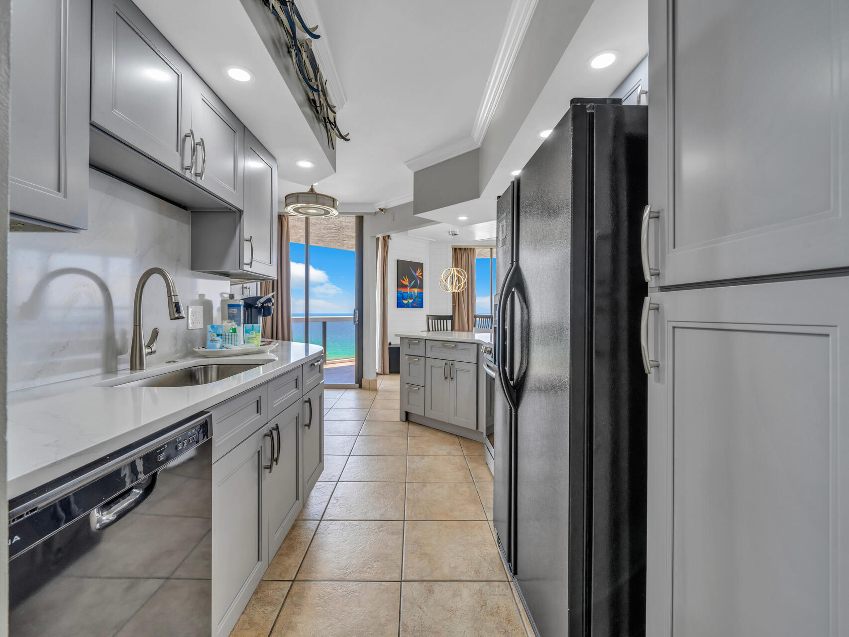 1096 Scenic Gulf Drive, Unit 1401/1401A Miramar Beach, FL 32550 - Photo 6 of 77 a kitchen with stainless steel appliances granite countertop a refrigerator and a sink