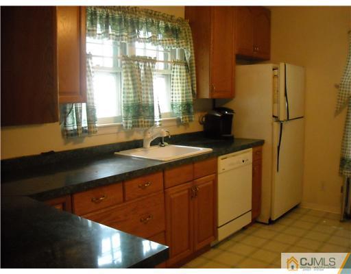 400 Bound Brook Road Middlesex, NJ 08846 - Photo 3 of 11 a kitchen with a sink and a refrigerator