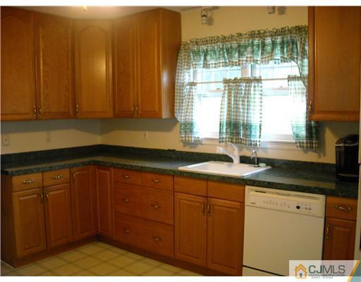 400 Bound Brook Road Middlesex, NJ 08846 - Photo 4 of 11 a kitchen with stainless steel appliances granite countertop a sink dishwasher and cabinets with wooden floor