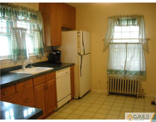 400 Bound Brook Road Middlesex, NJ 08846 - Photo 5 of 11 a bathroom with a sink a mirror and a shower