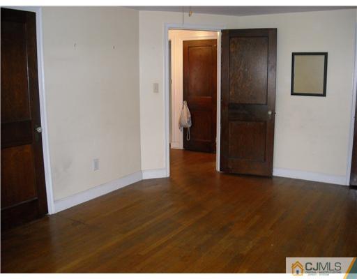 400 Bound Brook Road Middlesex, NJ 08846 - Photo 7 of 11 a view of an empty room with wooden floor and closet