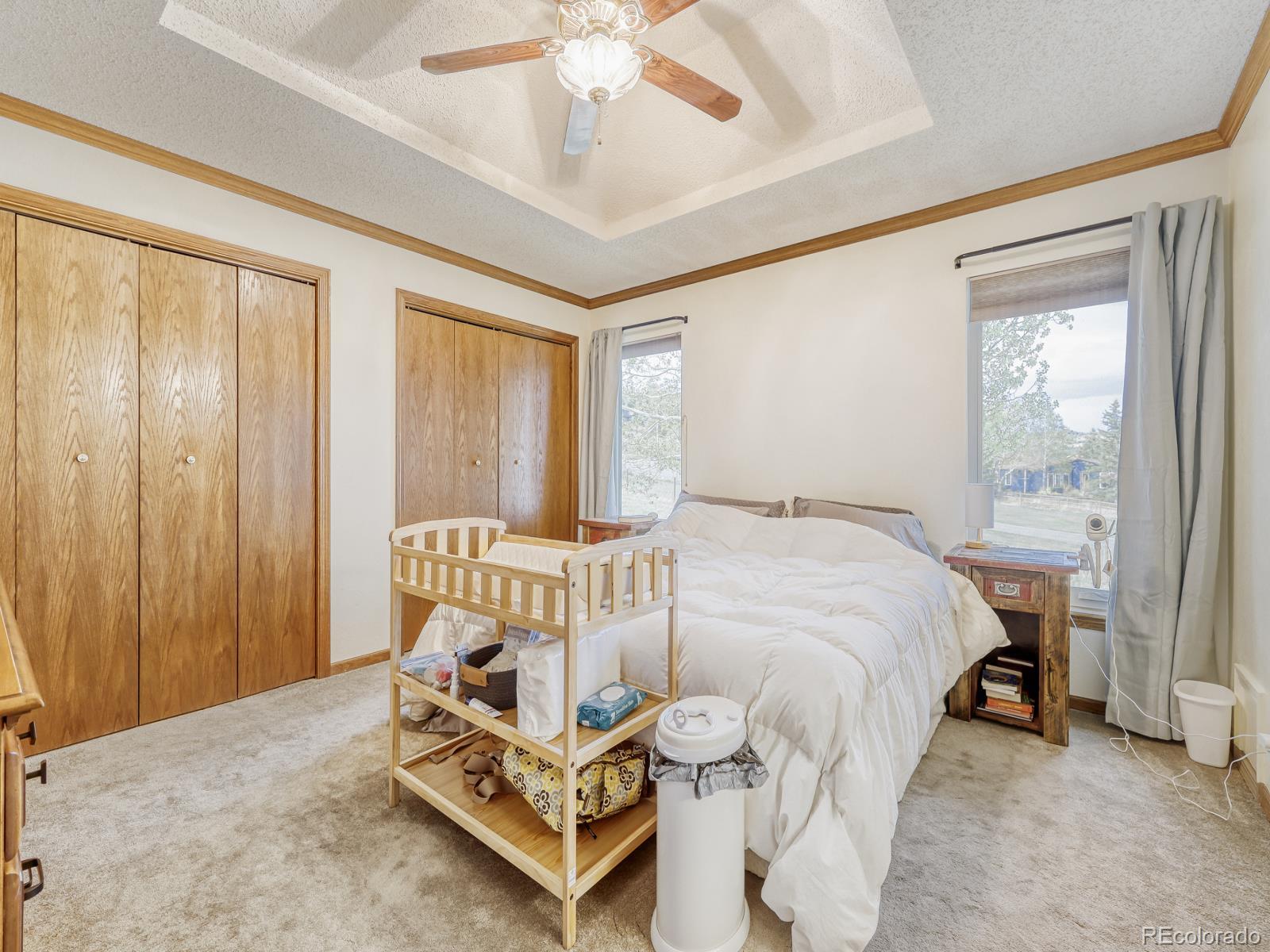 32020 Robinson Hill Road Golden, CO 80403 - Photo 18 of 28 a spacious bedroom with a bed and a window