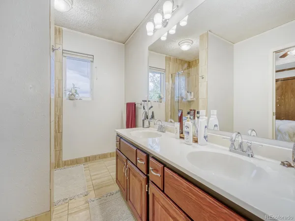 a bathroom with a sink double vanity and a mirror