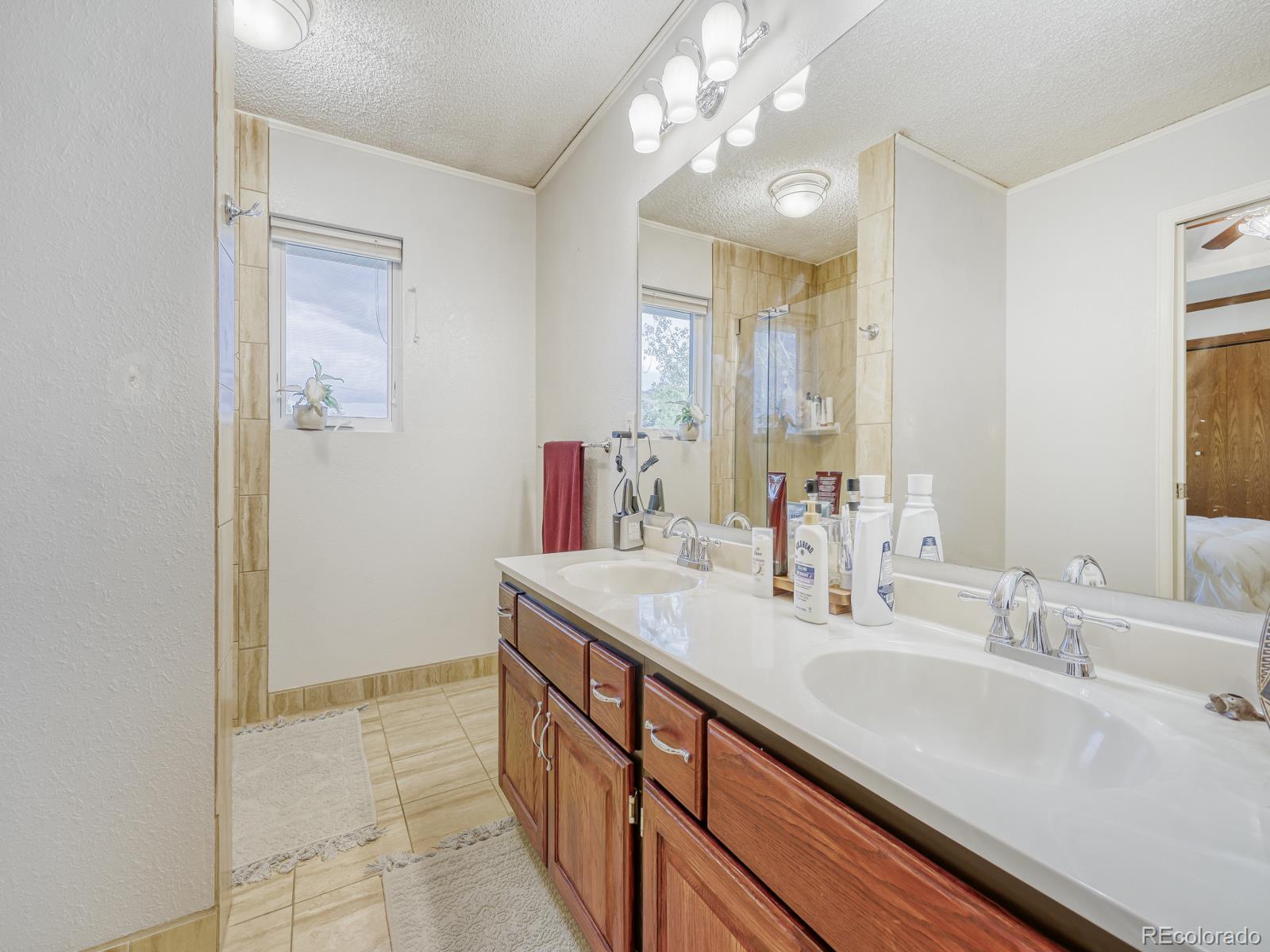 32020 Robinson Hill Road Golden, CO 80403 - Photo 20 of 28 a bathroom with a sink double vanity and a mirror