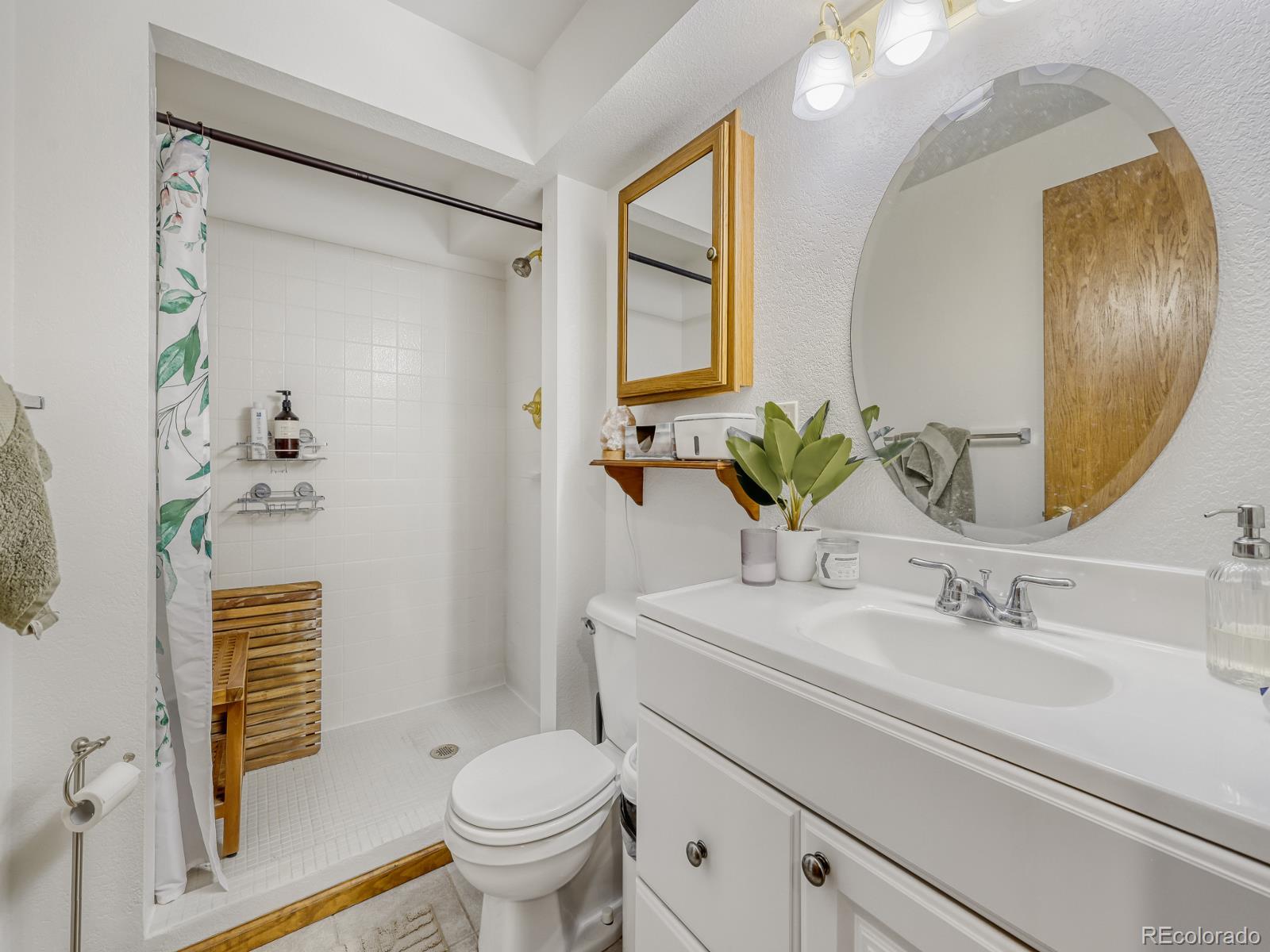 32020 Robinson Hill Road Golden, CO 80403 - Photo 27 of 28 a bathroom with a sink a toilet and a mirror