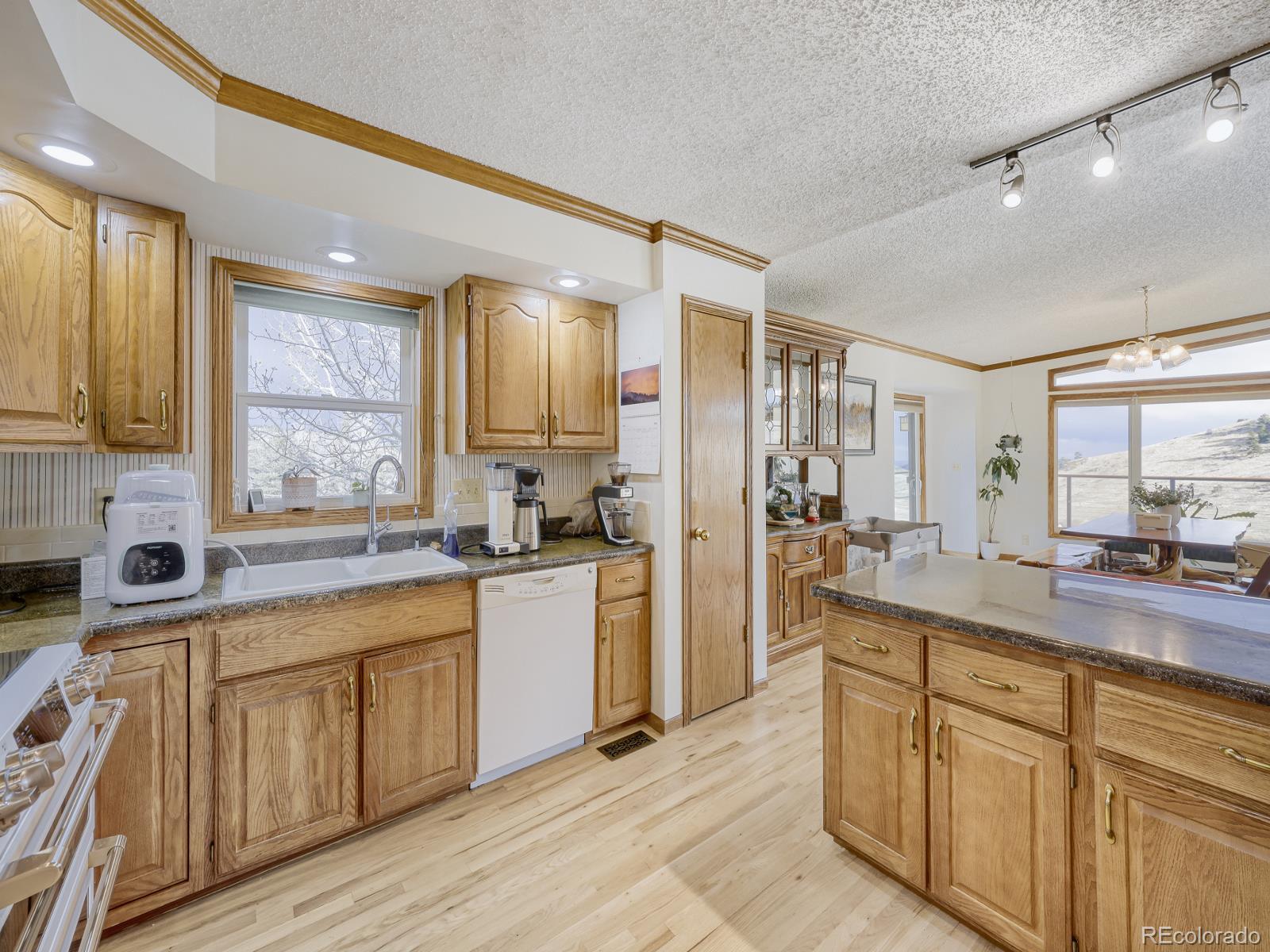 32020 Robinson Hill Road Golden, CO 80403 - Photo 10 of 28 a large kitchen with a lot of counter space and wooden floor