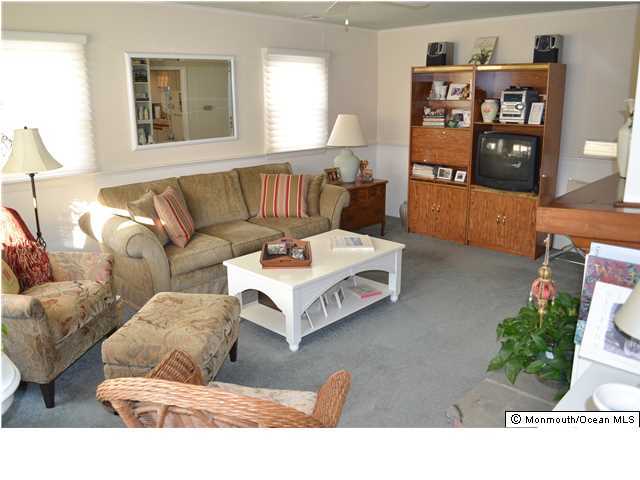 1417 Rue Mirador Point Pleasant, NJ 08742 - Photo 12 of 21 a living room with furniture and a book shelf