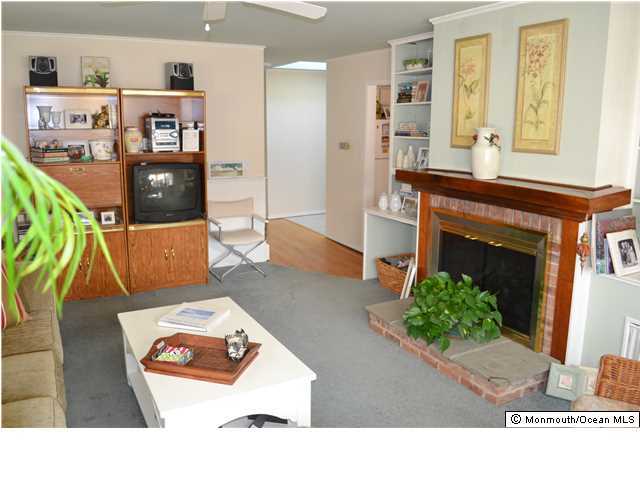 1417 Rue Mirador Point Pleasant, NJ 08742 - Photo 13 of 21 a living room with furniture and a fireplace