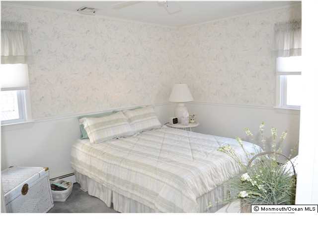 1417 Rue Mirador Point Pleasant, NJ 08742 - Photo 16 of 21 a bedroom with a bed and a lamp