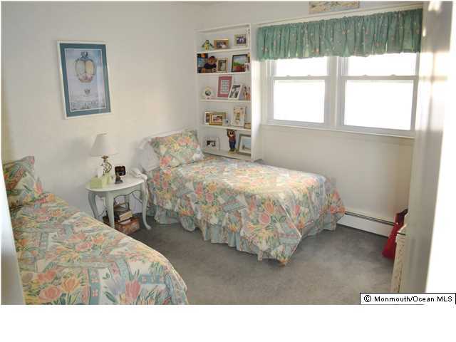 1417 Rue Mirador Point Pleasant, NJ 08742 - Photo 17 of 21 a bedroom with two beds and a window