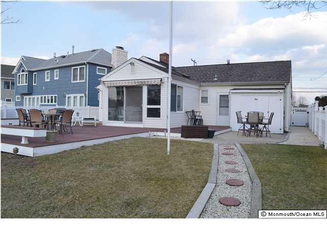 1417 Rue Mirador Point Pleasant, NJ 08742 - Photo 3 of 21 a backyard of a house with table and chairs