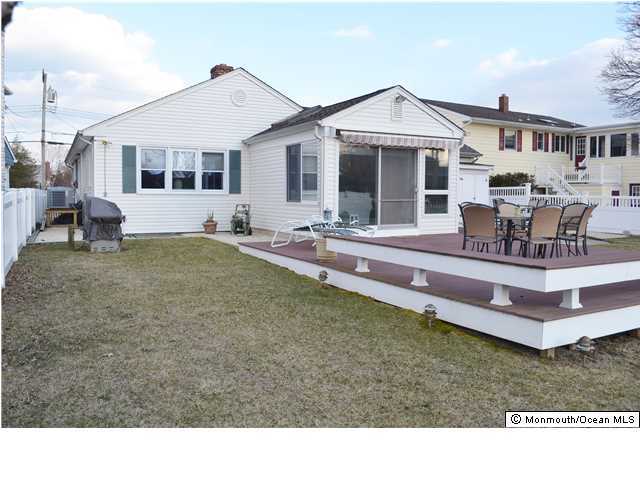 1417 Rue Mirador Point Pleasant, NJ 08742 - Photo 5 of 21 a front view of a house with a garden and patio