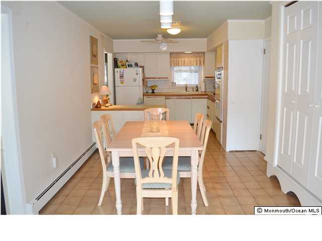 1417 Rue Mirador Point Pleasant, NJ 08742 - Photo 8 of 21 a dining room with stainless steel appliances kitchen island granite countertop a dining table and chairs