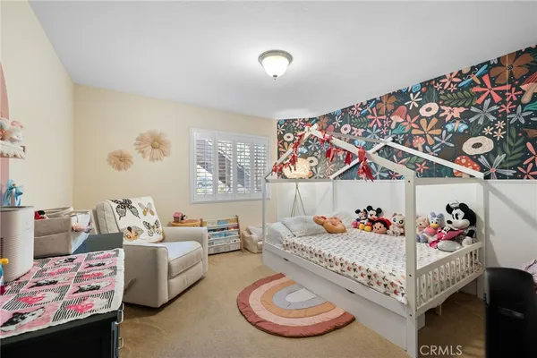 a bed room with furniture and a baby crib