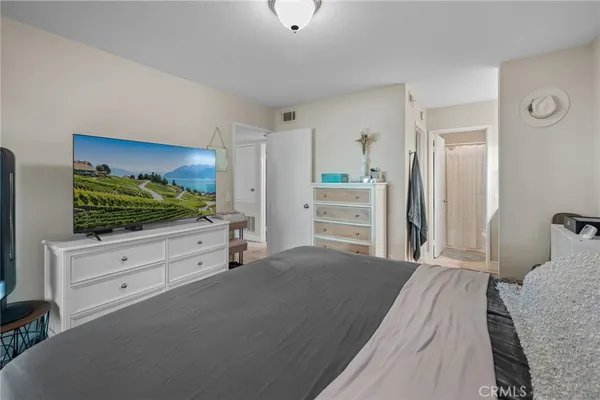a bedroom with a bed and a flat screen tv