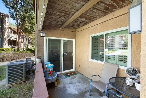 a view of a porch with chairs and a yard