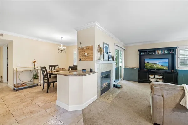 a living room with furniture a dining table and a floor to ceiling window