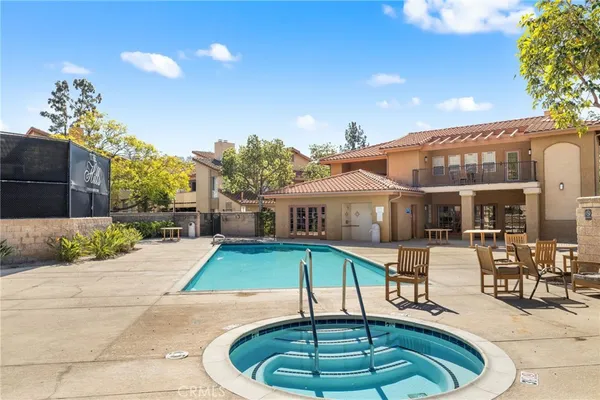 a house view with a swimming pool and sitting space