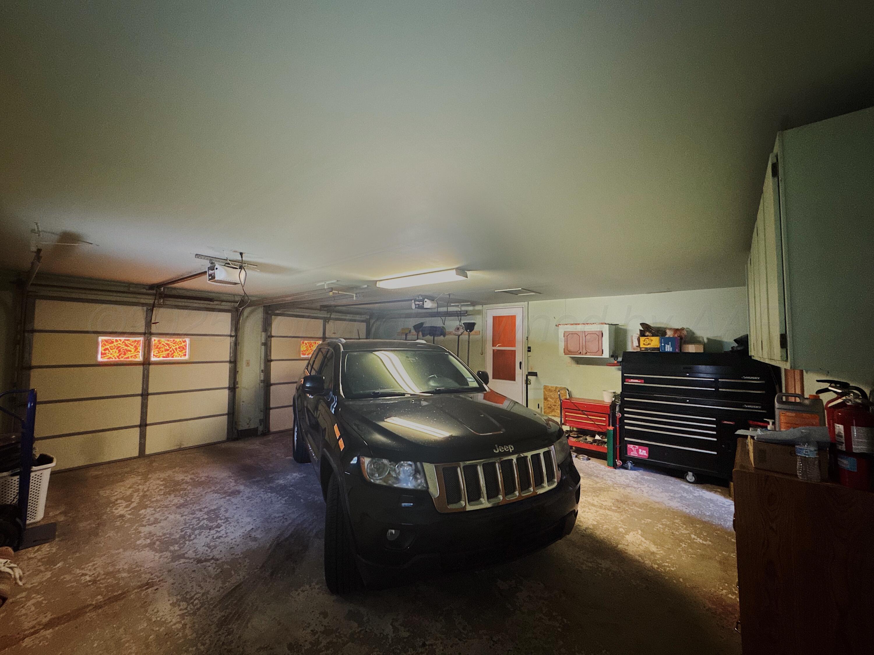 1421 South Fordham Street Perryton, TX 79070 - Photo 16 of 20 a room with furniture and a chandelier