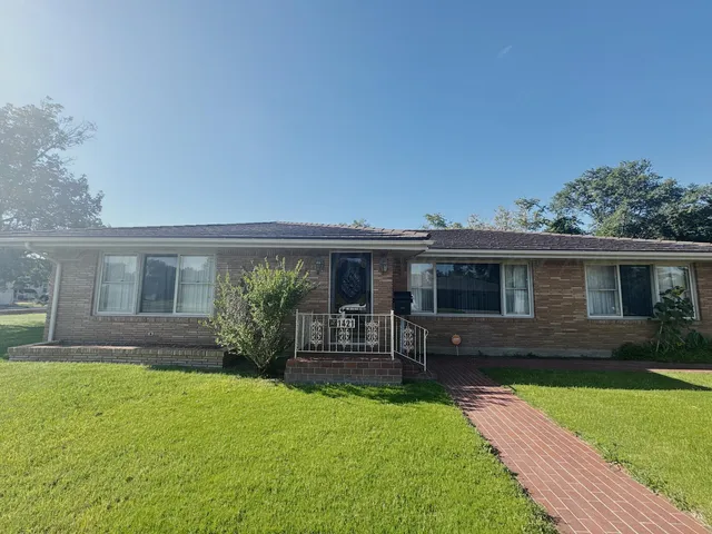 a front view of house with yard and outdoor seating