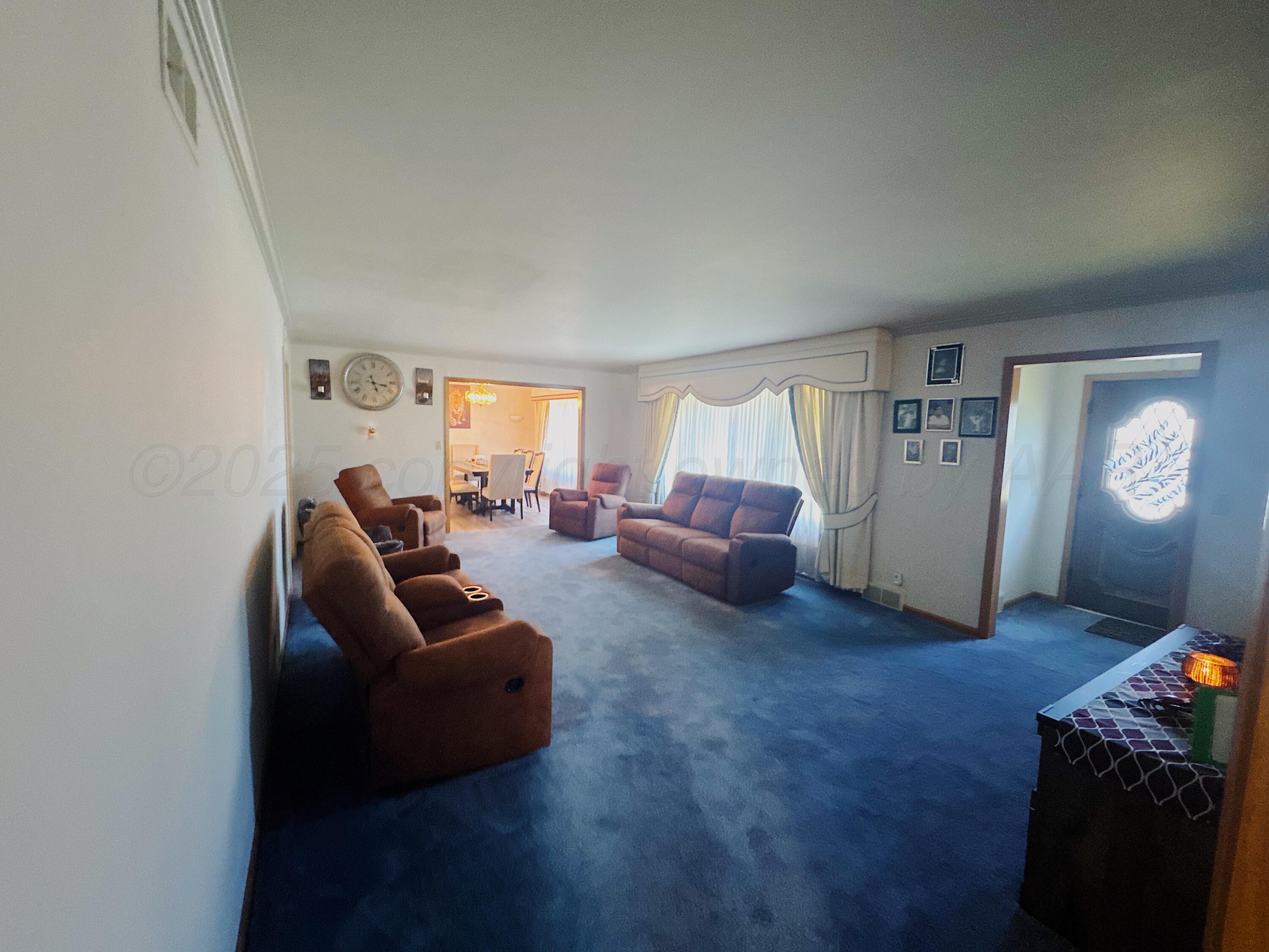 1421 South Fordham Street Perryton, TX 79070 - Photo 4 of 20 a living room with furniture and a window