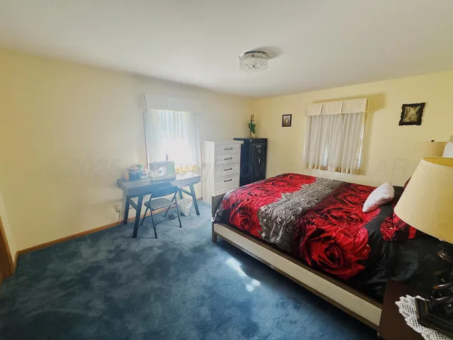 a bedroom with a bed and a table in it