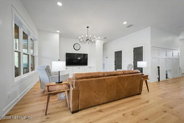 a living room with furniture and a chandelier