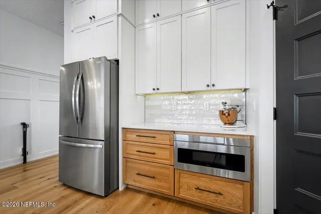 a bedroom with a bed a lamp and potted plant
