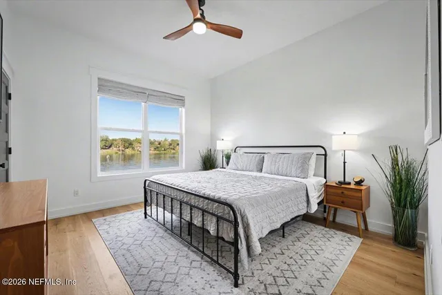 a bedroom with a bed a couch and a window