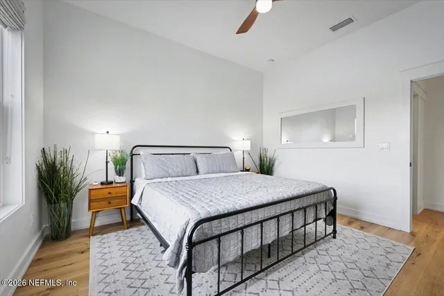 a bedroom with a bed and a window