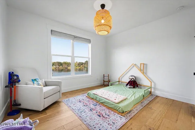 a spacious bedroom with a bed and window