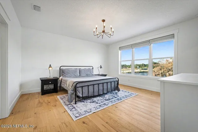 a bathroom with a sink a toilet a mirror and shower