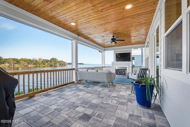 an aerial view of a house with garden space and lake view