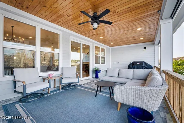 an aerial view of a house with a yard and lake view