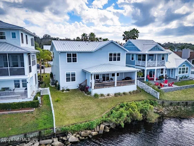 an aerial view of a house with a lake view