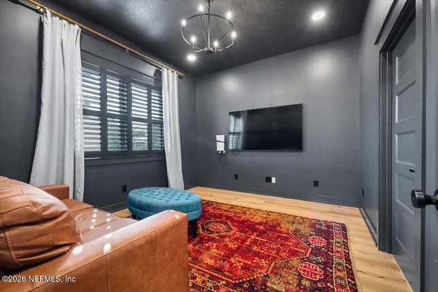 a living room with furniture a rug and a window