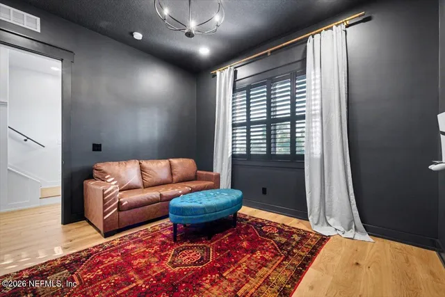 a view of a livingroom with furniture wooden floor and window