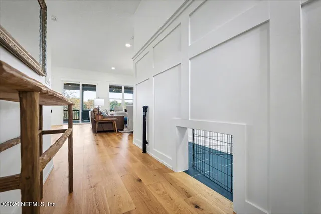a living room with furniture a flat screen tv and a large window