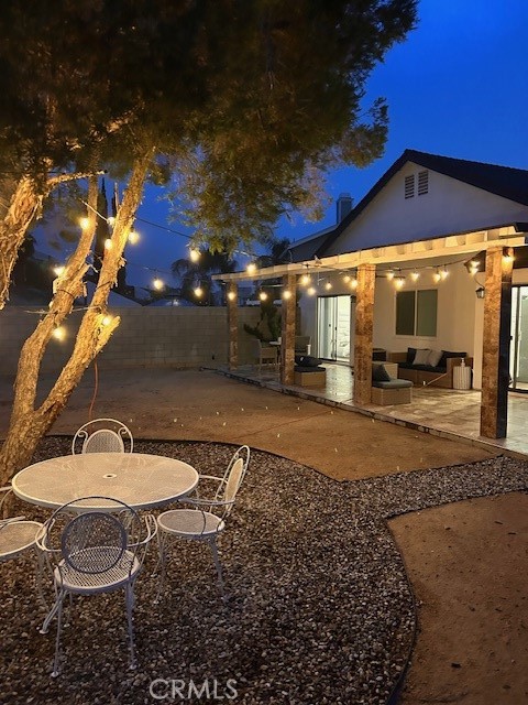 a backyard of a house with barbeque oven table and chairs