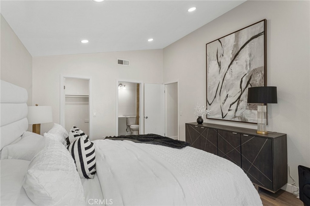 23020 Mansfield Lane Moreno Valley, CA 92557 - Photo 11 of 28 a bedroom with a bed and dresser with mirror