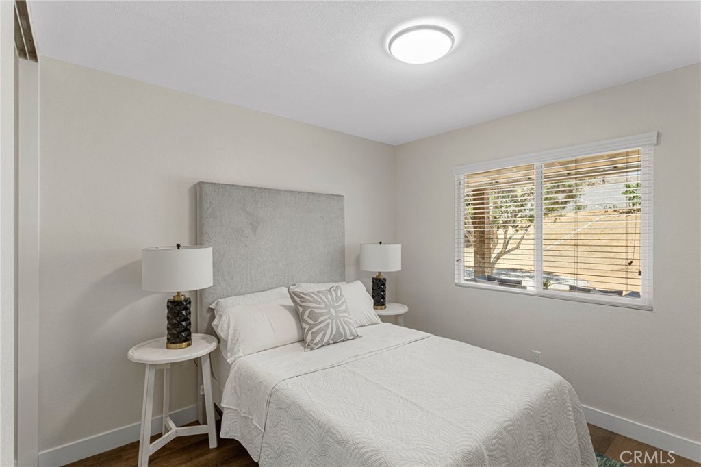 23020 Mansfield Lane Moreno Valley, CA 92557 - Photo 12 of 28 a bedroom with a bed and a table in it