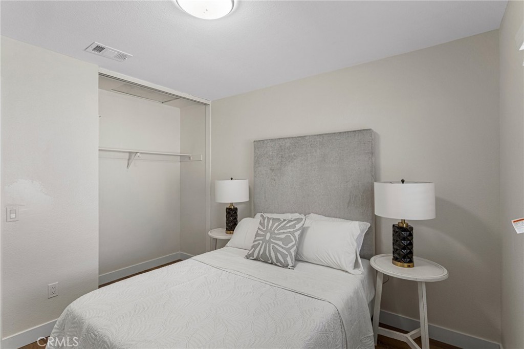 23020 Mansfield Lane Moreno Valley, CA 92557 - Photo 13 of 28 a bedroom with a bed and a table