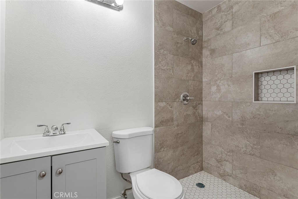 23020 Mansfield Lane Moreno Valley, CA 92557 - Photo 17 of 28 a bathroom with a sink a toilet and shower