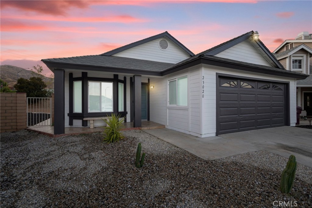 23020 Mansfield Lane Moreno Valley, CA 92557 - Photo 2 of 28 a front view of a house with a yard and garage
