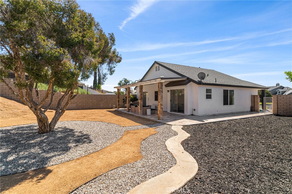 23020 Mansfield Lane Moreno Valley, CA 92557 - Photo 22 of 28 a front view of a house with a yard