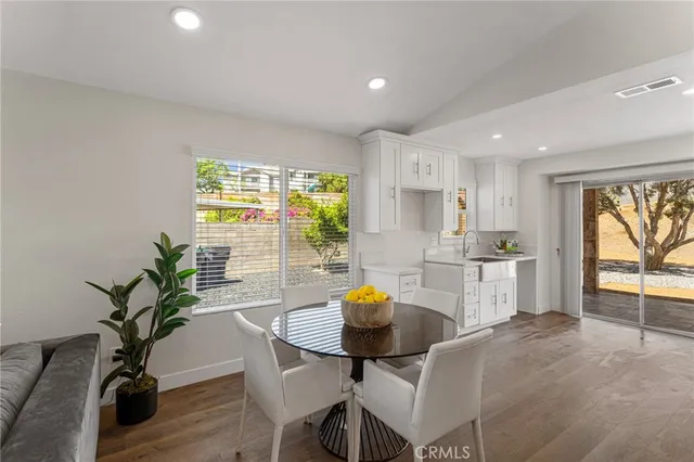 a kitchen with a table and chairs in it
