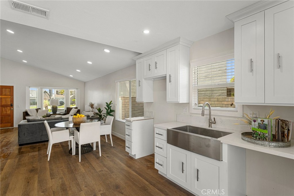 23020 Mansfield Lane Moreno Valley, CA 92557 - Photo 8 of 28 a kitchen with stainless steel appliances sink dining table and chairs