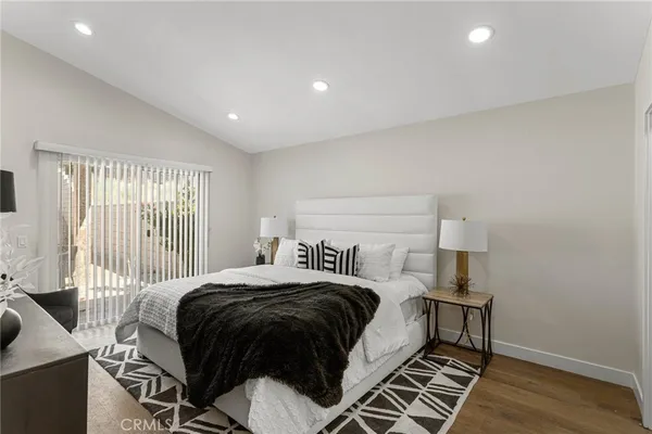 a bedroom with a bed and wooden floor