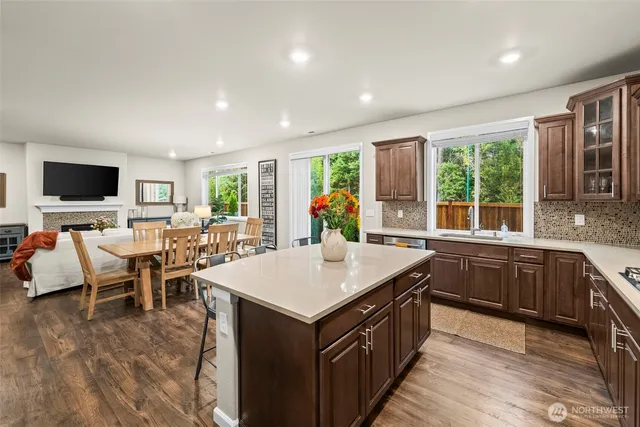 a kitchen with stainless steel appliances granite countertop a sink and a refrigerator