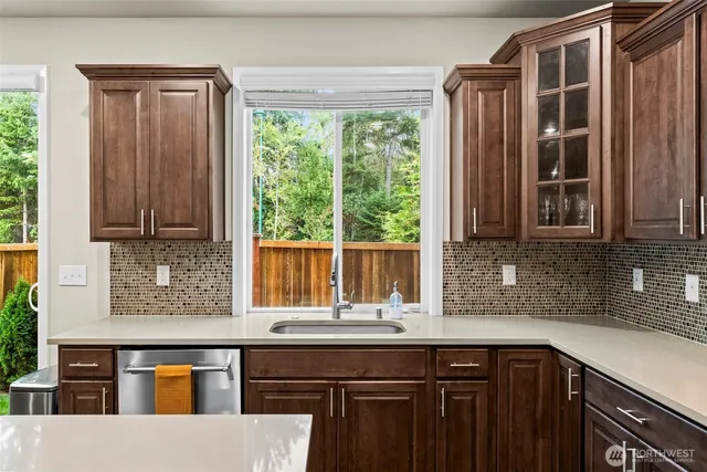 a open dining room with stainless steel appliances kitchen island granite countertop a dining table chairs and granite counter tops